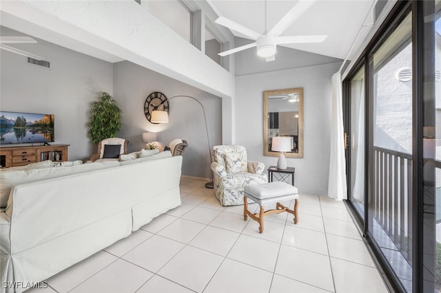 interior space featuring light tile patterned floors, vaulted ceiling, and ceiling fan