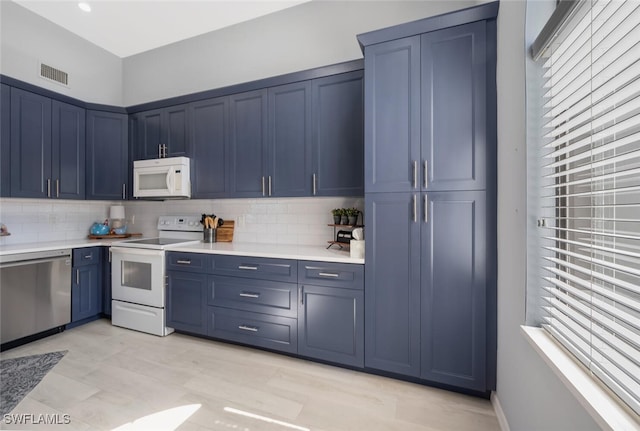 kitchen featuring blue cabinetry and white appliances