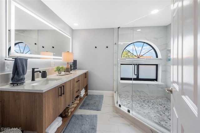 bathroom featuring walk in shower and vanity