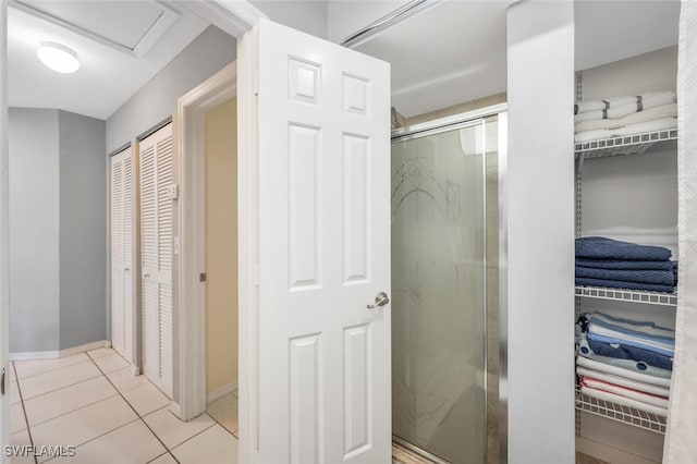 bathroom featuring tile patterned flooring and a shower with shower door