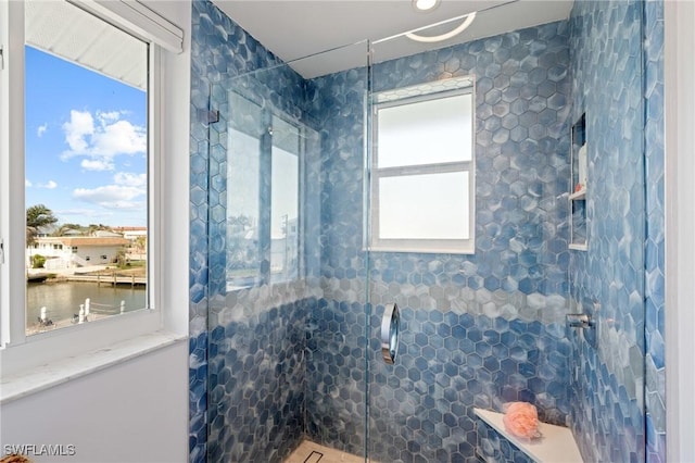 bathroom with an enclosed shower and a water view