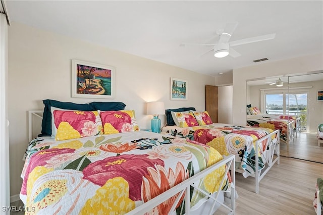 bedroom featuring ceiling fan, light hardwood / wood-style flooring, and access to outside