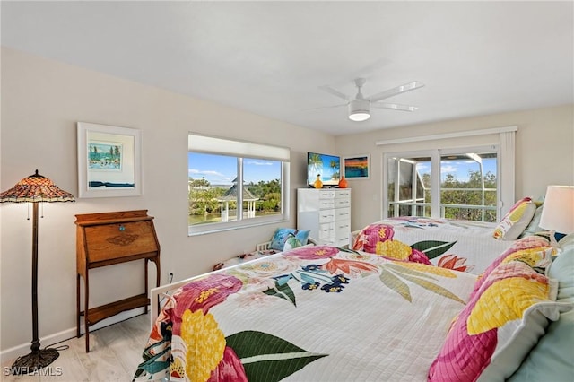 bedroom featuring access to outside, ceiling fan, and light wood-type flooring