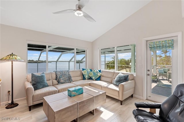 living room featuring a water view, ceiling fan, high vaulted ceiling, and light wood-type flooring