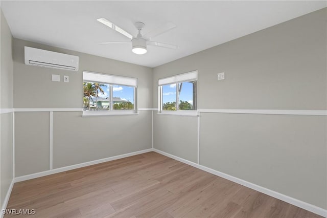 291 Flamingo St, Fort Myers Beach, FL 33931 - spare room featuring baseboards, a wall mounted AC, wood finished floors, and a ceiling fan