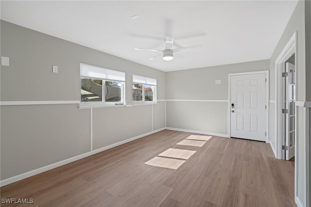 empty room featuring ceiling fan and light hardwood / wood-style floors