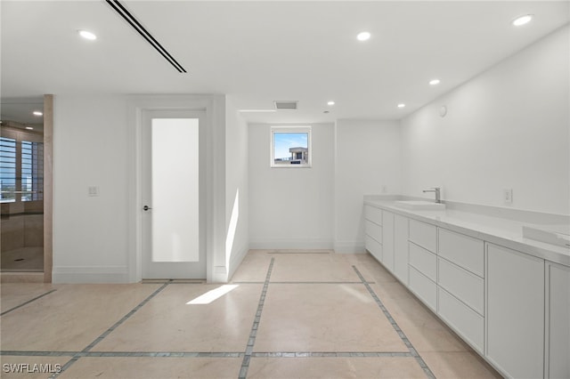 bathroom with walk in shower and vanity