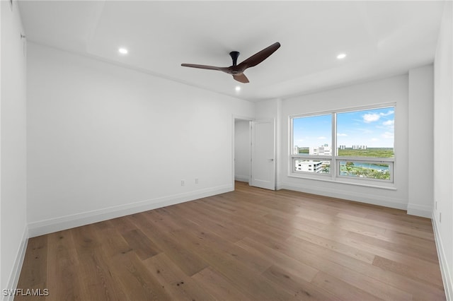 empty room with hardwood / wood-style flooring and ceiling fan