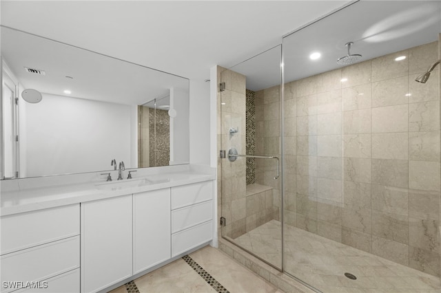 bathroom with vanity and a shower with door