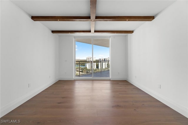 empty room featuring dark hardwood / wood-style flooring, beam ceiling, and expansive windows