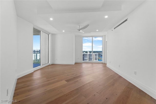 unfurnished room with ceiling fan and hardwood / wood-style floors