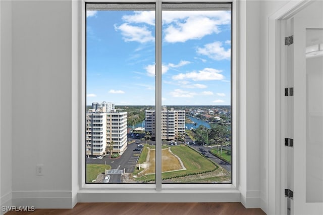 doorway to outside with a water view and wood-type flooring