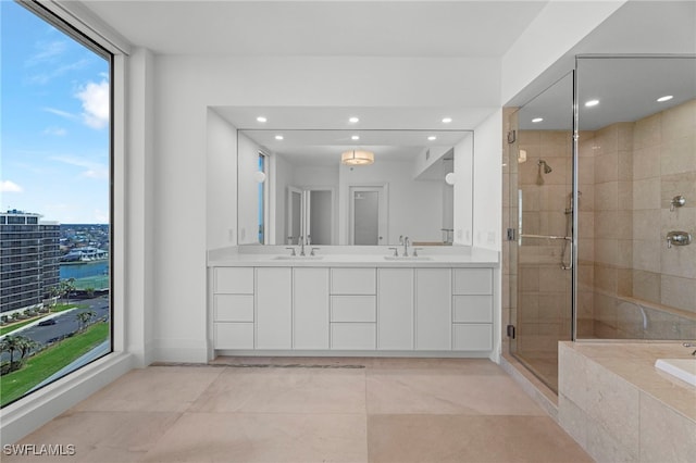 bathroom with plus walk in shower, vanity, and tile patterned floors