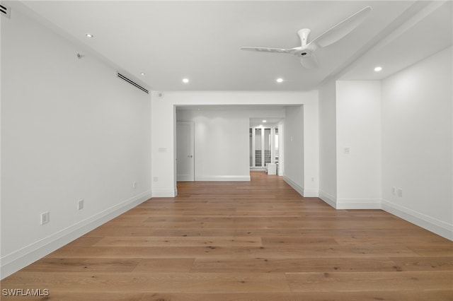 spare room with ceiling fan and light wood-type flooring