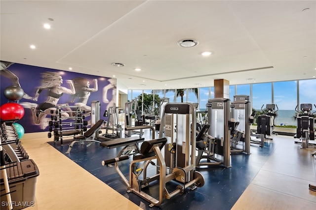 gym featuring expansive windows and a water view