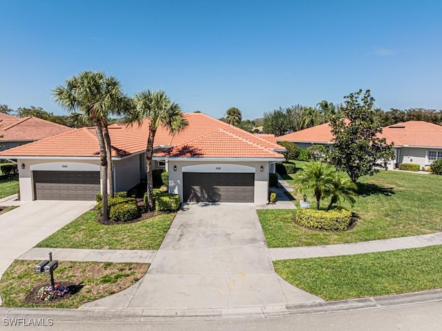 mediterranean / spanish-style house featuring a front yard, concrete driveway, a tiled roof, and stucco siding