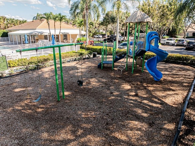 community jungle gym featuring fence