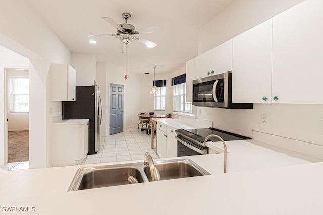 2081 Crestview Way, Naples, FL 34119 - kitchen featuring stainless steel appliances, a sink, white cabinetry, light countertops, and ceiling fan