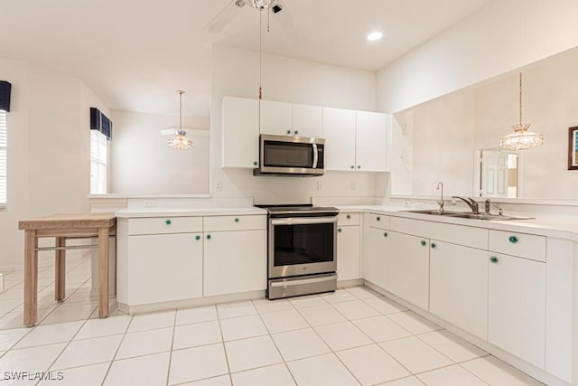 2081 Crestview Way, Naples, FL 34119 - kitchen with appliances with stainless steel finishes, a peninsula, light countertops, pendant lighting, and a sink