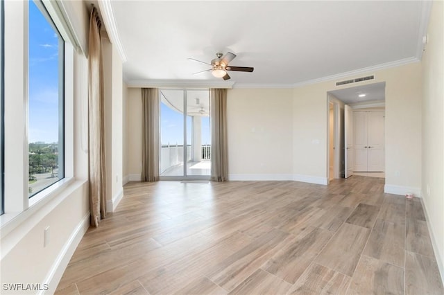 unfurnished room with light wood finished floors, visible vents, and crown molding