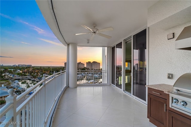 balcony at dusk featuring ceiling fan and a grill