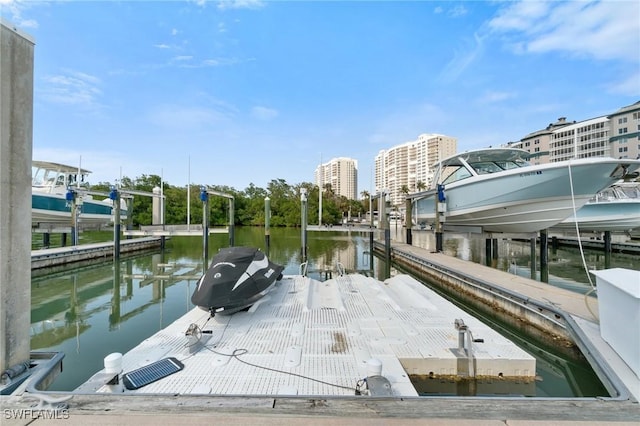 dock area featuring a view of city, a water view, and boat lift