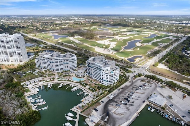 bird's eye view with view of golf course, a water view, and a city view