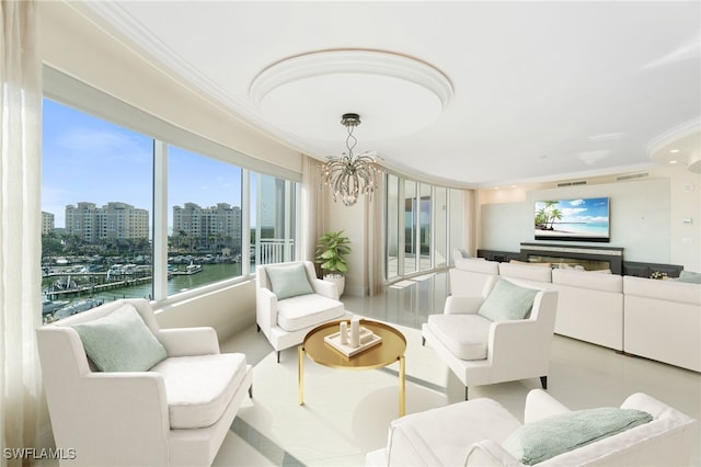 living area with a notable chandelier, crown molding, visible vents, and a city view