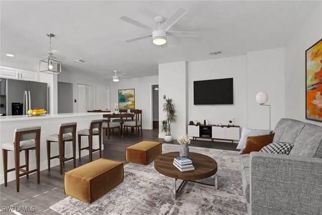 living room with hardwood / wood-style flooring and ceiling fan