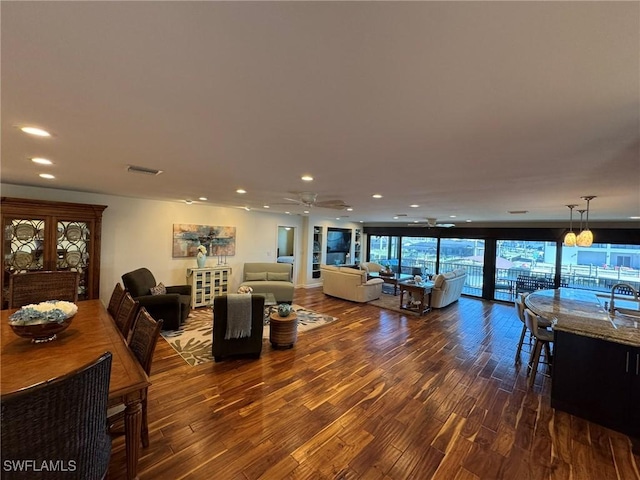 living room featuring dark wood-type flooring and sink