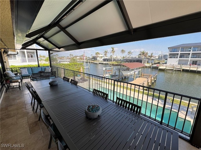 wooden terrace with a water view, a dock, an outdoor living space, a fenced in pool, and a patio