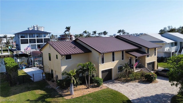 view of front of house featuring a garage and a front lawn