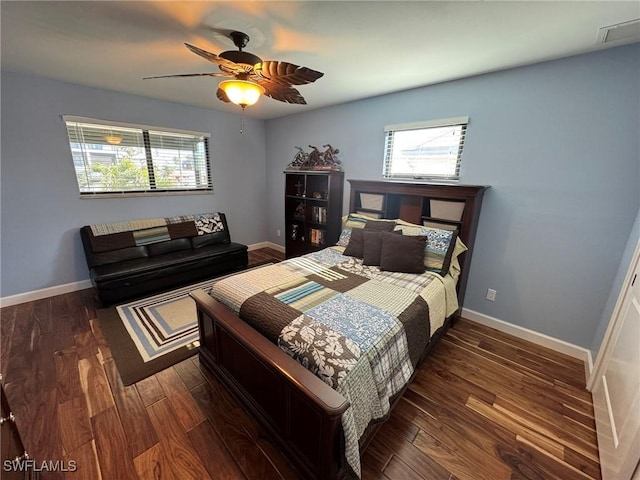 bedroom with dark hardwood / wood-style flooring and ceiling fan