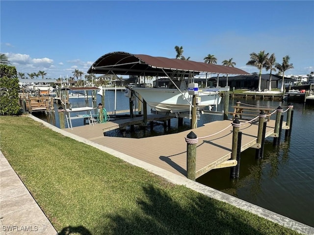 dock area featuring a lawn and a water view