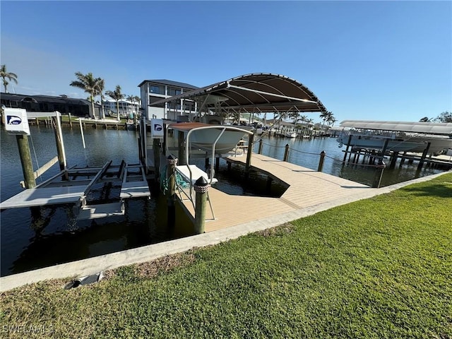 dock area with a yard and a water view