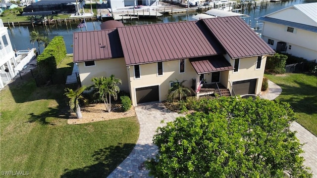 birds eye view of property with a water view