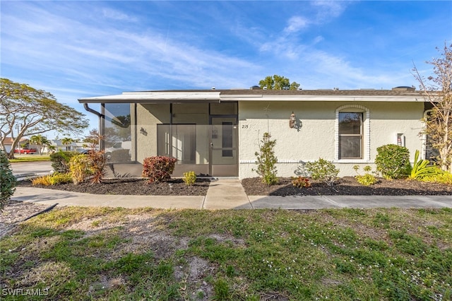 rear view of property featuring a sunroom