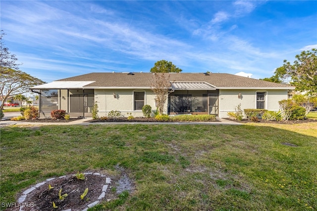 view of front of home with a sunroom and a front lawn