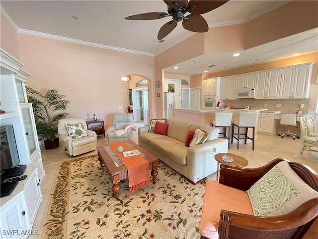 living room with light tile patterned floors, ornamental molding, and ceiling fan