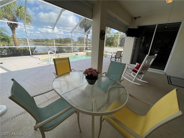 view of patio / terrace with a water view and glass enclosure