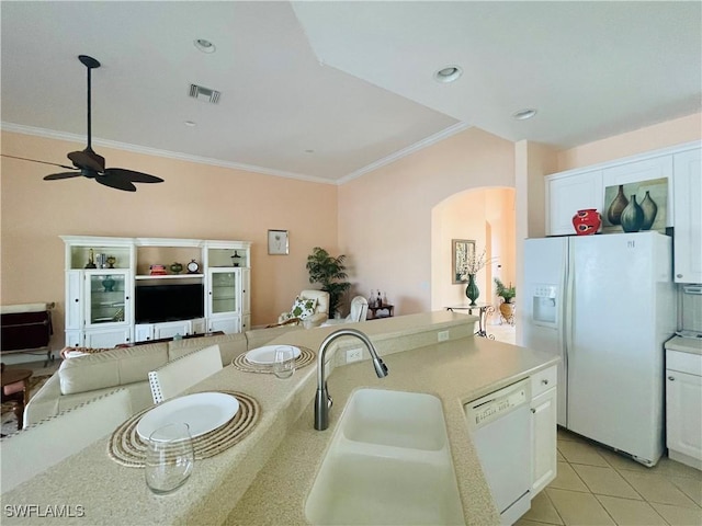 kitchen with light tile patterned flooring, sink, white cabinetry, crown molding, and white appliances