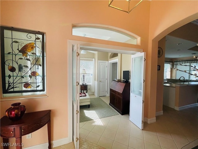 hall with light tile patterned floors