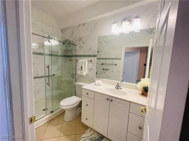 bathroom with vanity, toilet, a shower with shower door, and tile patterned flooring