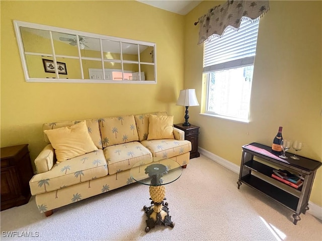 carpeted living room featuring ceiling fan