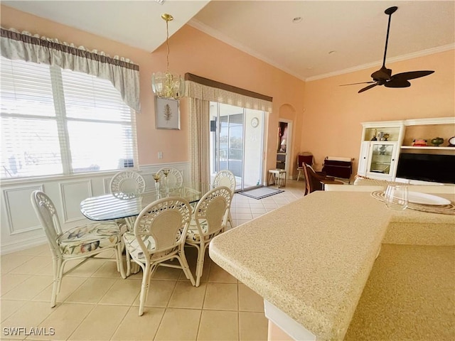 tiled dining room featuring ornamental molding and ceiling fan