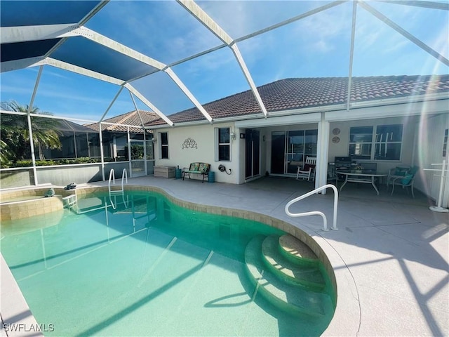 view of pool with a patio and glass enclosure