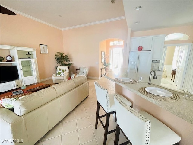 tiled living room featuring ornamental molding