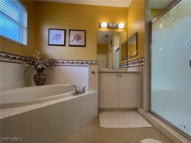 bathroom with independent shower and bath, vanity, and tile patterned floors