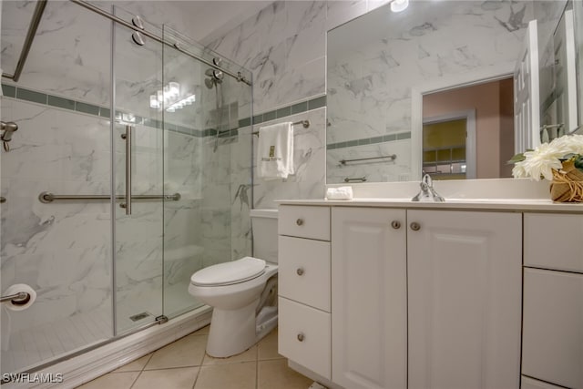 full bath featuring toilet, a shower stall, vanity, and tile patterned floors