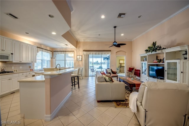 living room featuring light tile patterned floors, a wealth of natural light, and visible vents